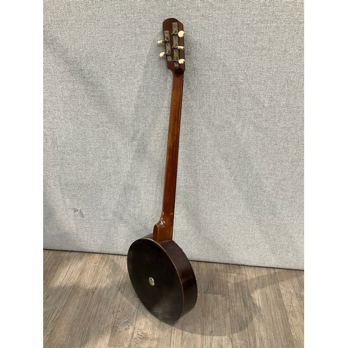 5169 - An early 20th Century five string banjo with original case, no maker, split to back