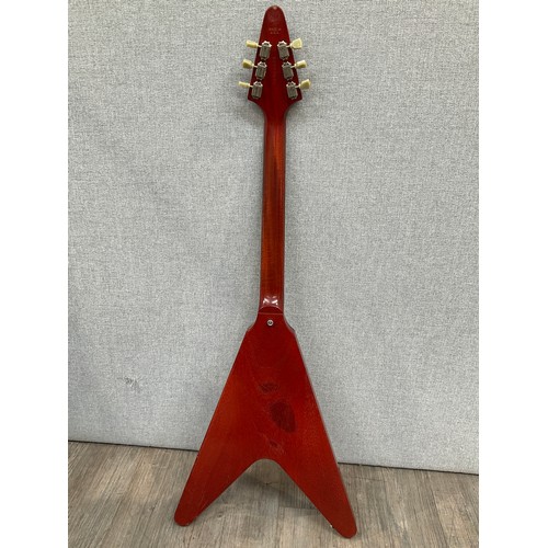 5205 - A Gibson Flying V electric guitar with worn cherry body, white three-ply pickguard and crescent moon... 