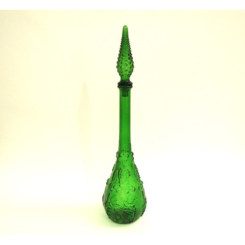 7151 - An Italian Empoli green glass bottle decanter and stopper with mould vine detail. Overall 54cm high