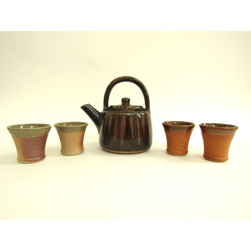 7106 - A John Leach Muchelney Pottery teapot, 17cm high together with four small cups, 6cm high