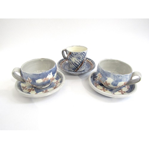 7140 - Three Jo Rollason studio pottery Cappuccino cups and saucers. Tallest 9.5cm