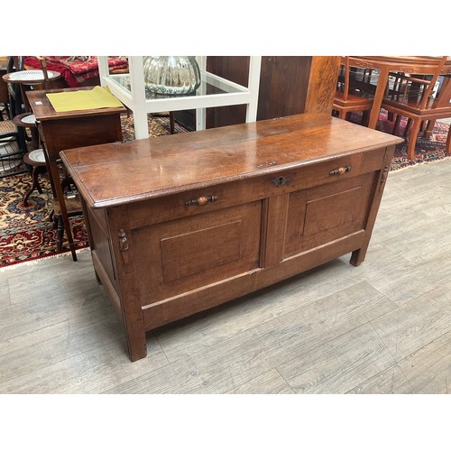 1113 - An 18th Century oak coffer, panelled front, split pins to top, 64.5cm tall x 130cm wide x 56cm deep