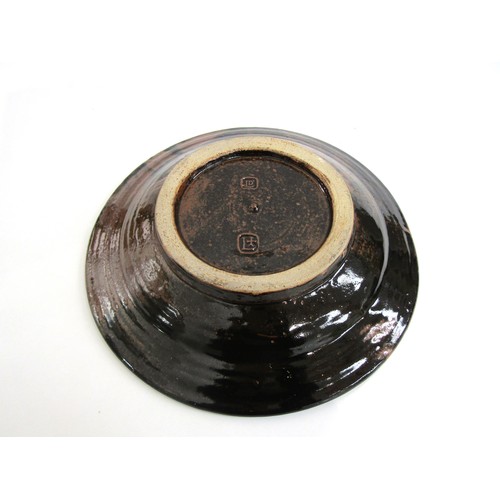 7074 - DAVID LEACH OBE (1911-2005) (ARR) A Lowerdown Pottery stoneware charger with Dolomite glaze over ten... 