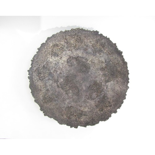 7117 - BARRY GUPPY (1937-2013) A large studio pottery charger with textured detail. Impressed seal and date... 