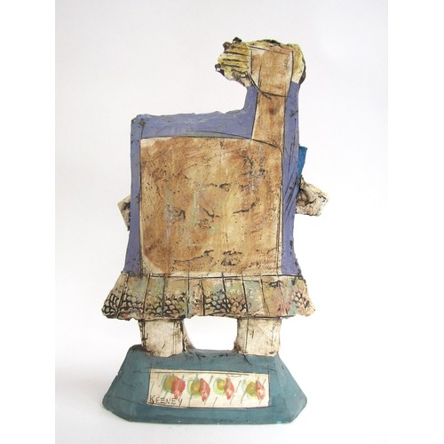 7057 - CHRISTY KEENEY (b.1958): A studio pottery figure of an accordian player, signed verso, 41.5cm high (... 