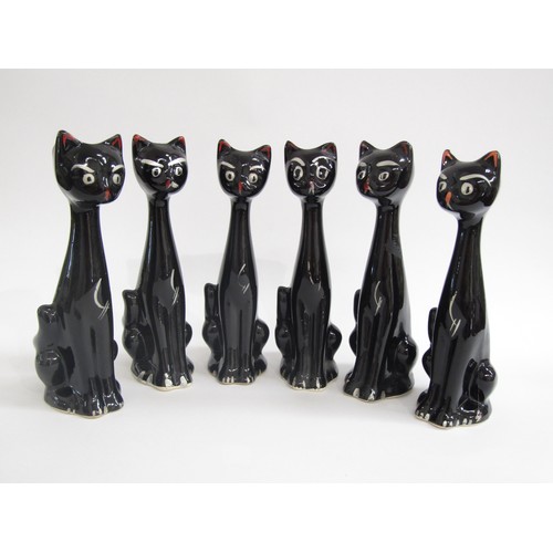 7027 - A group of six Italian pottery cats, black glazed.  22.5cm high