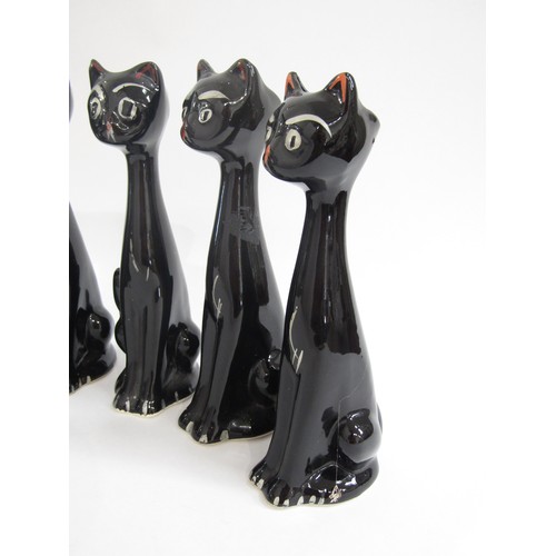 7027 - A group of six Italian pottery cats, black glazed.  22.5cm high