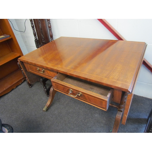 1008 - A reproduction mahogany sofa table, twin frieze drawers, reeded supports, brass lion paw feet