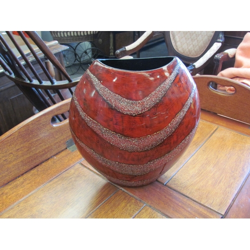 1109 - A modernistic vase of circular form with textured bands