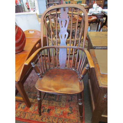 1114 - An elm seated Windsor hoop-back country chair, fiddle splat, on turned supports joined by a stretche... 