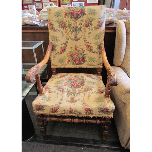 1126 - A 19th Century French walnut framed armchair, foliate needlepoint seat and back, scrolled carved arm... 