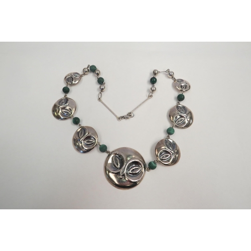 1267 - A graduated circular mask panel necklace spaced by malachite beads, stamped 925