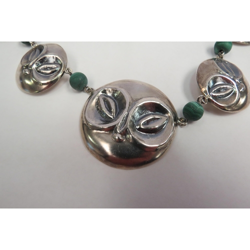 1267 - A graduated circular mask panel necklace spaced by malachite beads, stamped 925