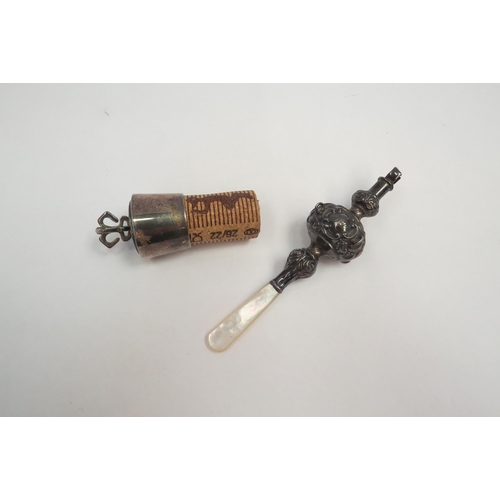 1269 - A mother-of-pearl handled rattle and a cork topper with crown to top