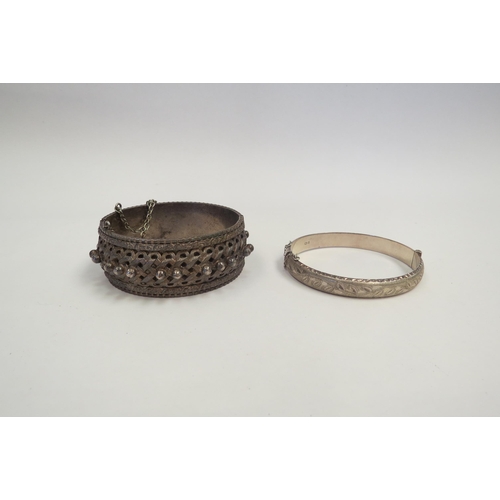 1279 - A silver bangle and another white metal ornate example  (C)