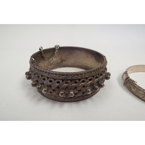 1279 - A silver bangle and another white metal ornate example  (C)