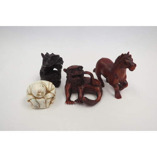 1308 - Three boxwood netsuke - horse, dragon, Chinese Dog of Fo and an ivorine figure