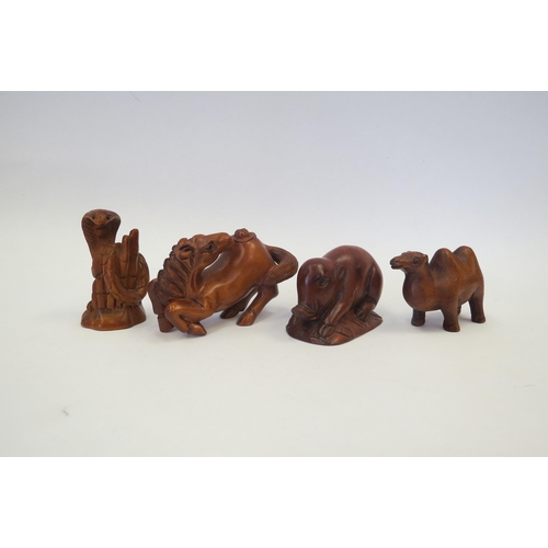 1313 - Four boxwood netsuke - serpent, pig, camel, horse, three signed