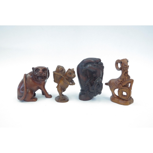 1314 - Four boxwood netsuke - lion, ram, dragon in fish, cat with fish basket, three signed