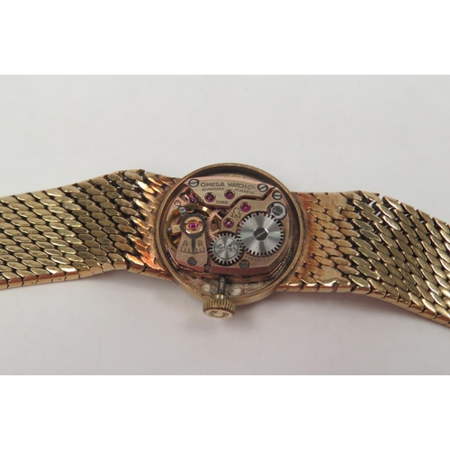 1317 - A 9ct gold Omega lady’s wristwatch, round face with line markers, 28.9g