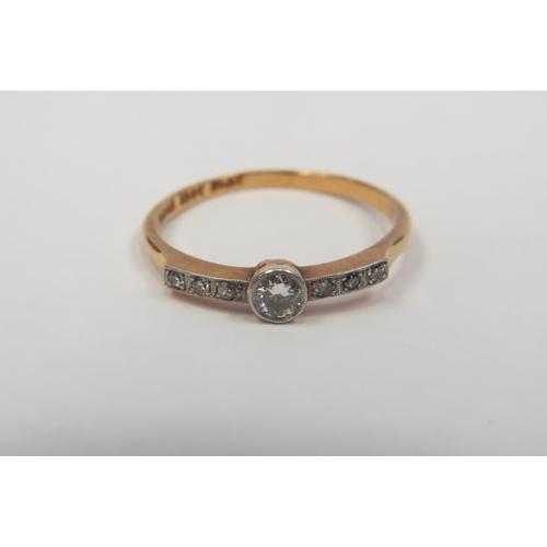 1321 - An 18ct gold platinum set diamond ring, central round-cut flanked by six chip diamonds to the should... 