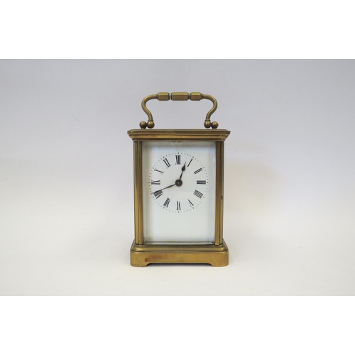 1341 - A brass cased carriage clock, enamel face, Roman numeral dial, with key