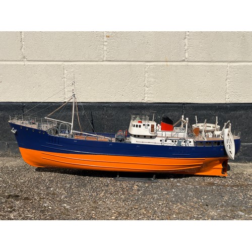 8009 - A model of a fishing vessel, orange and blue hull, 107cm length