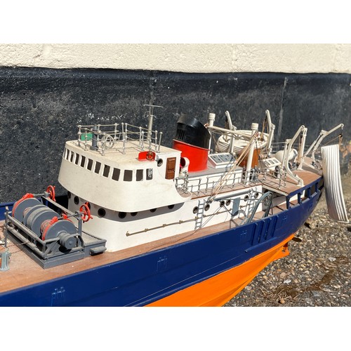 8009 - A model of a fishing vessel, orange and blue hull, 107cm length