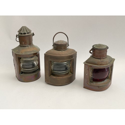 8100 - Three small copper ship’s lanterns including port and heklight, ranging from 22cm to 28cm high