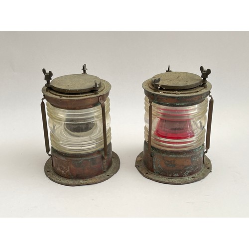 8097 - Two ship’s copper cased lamps, one with red lens, with plaques Meteorite 1090 and 1092