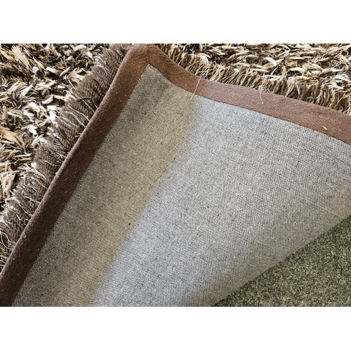 1500 - A brown and beige shag pile rectangular ground rug, 165cm x 225cm    (R)  £30