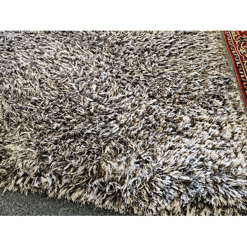 1500 - A brown and beige shag pile rectangular ground rug, 165cm x 225cm    (R)  £30