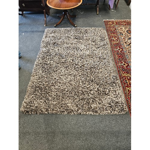 1500 - A brown and beige shag pile rectangular ground rug, 165cm x 225cm    (R)  £30