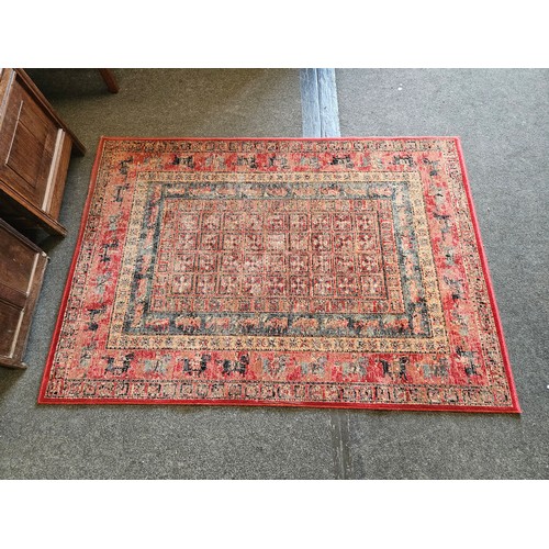 1501 - A Persian style red ground Bokhara rug, 189cm x 133cm