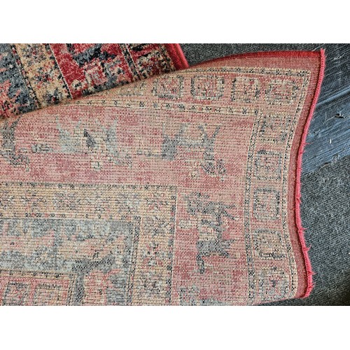 1501 - A Persian style red ground Bokhara rug, 189cm x 133cm