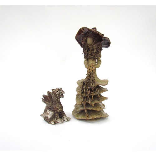 7124 - A studio pottery figure of a girl and a similar studio pottery dragon figurine. Tallest 32cm