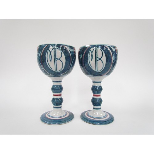 7130 - A pair of Aldermaston Pottery studio goblets by Alan Caiger Smith, painted marks to base.  18cm high... 