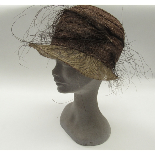 6033 - A hat box containing a 1920's mushroom coloured sisal cloche hat with black feather detail, possibly... 