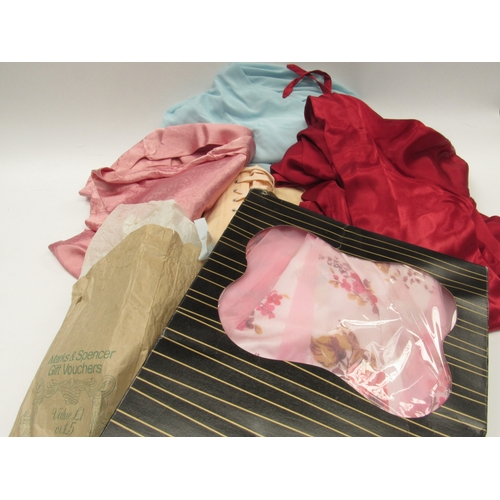 6037 - A quantity of mid 20th Century ladies' undergarments comprising nylon petticoats with netting, blush... 