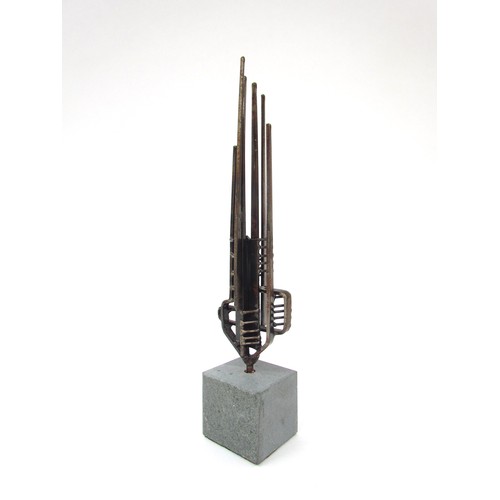 7549 - A stylised abstract metal sculpture on a stone base, unsigned. 25cm high