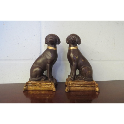 1011 - A pair of dog figures sitting on pillows, gilt effect to collars and pillows, 20cm tall