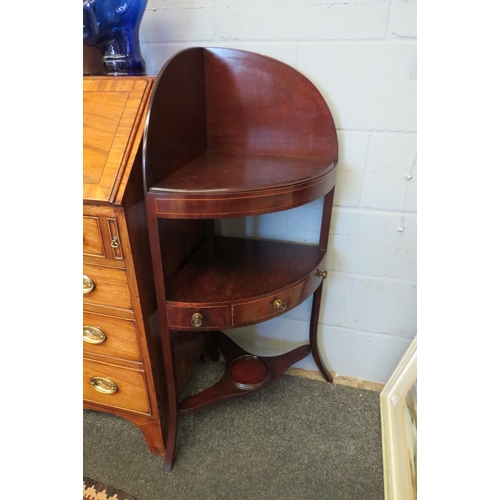 1068 - A George III line inlaid mahogany three tier corner washstand with central drawer over outswept legs... 