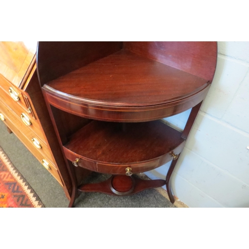 1068 - A George III line inlaid mahogany three tier corner washstand with central drawer over outswept legs... 