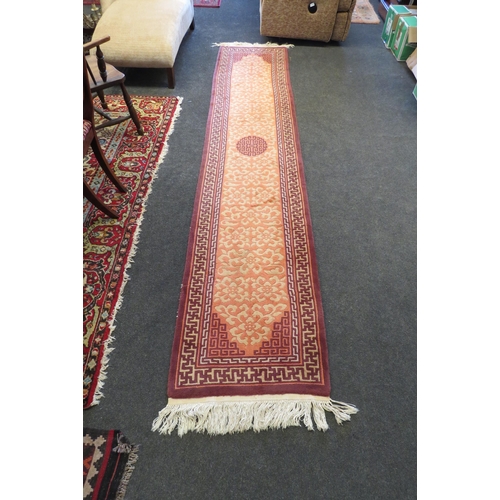 1081 - A peach and beige Chinese pattern hall runner with tassel ends, approx. 332cm long (without tassels)... 