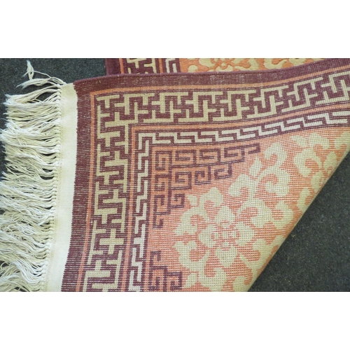 1081 - A peach and beige Chinese pattern hall runner with tassel ends, approx. 332cm long (without tassels)... 