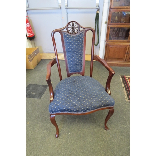 1089 - An Edwardian carved mahogany armchair, the blue upholstered serpentine front seat over cabriole fore... 