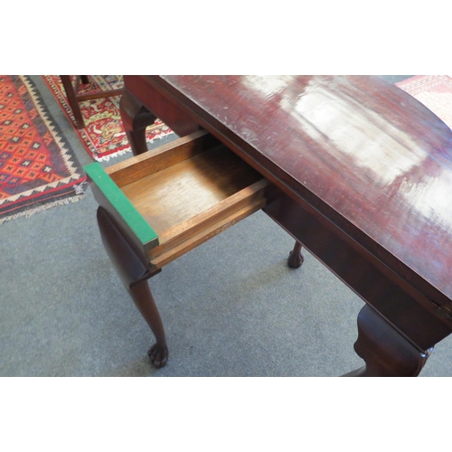 1102 - A demi-lune carved edge top games table, the baize lined circular top over a pull-out rear support l... 