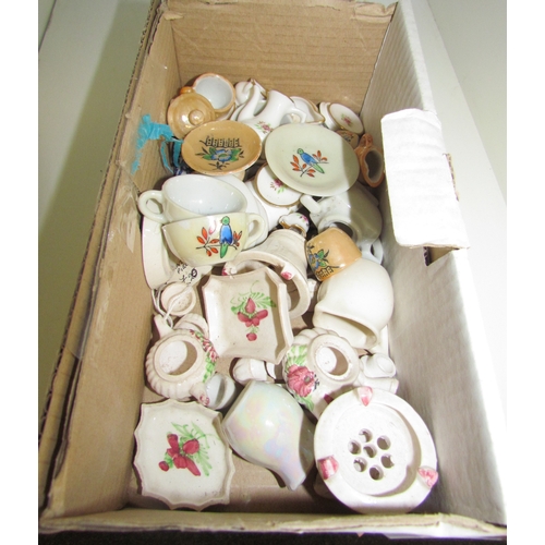 1388 - A box containing miniature ceramics, teapots, cups, etc