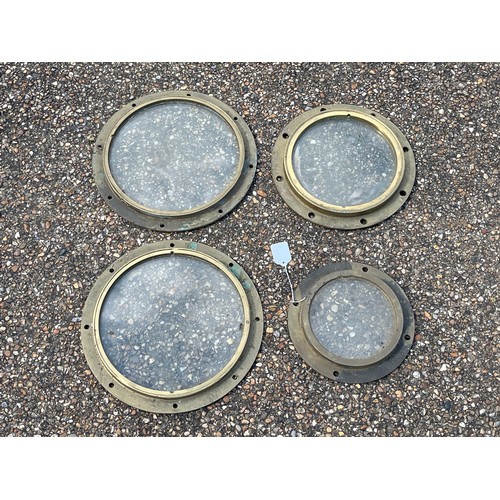 8076 - Four various sized brass ship’s portholes