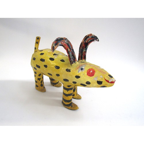 7552 - JULIE ARKELL (XX/XXI) A a folk art papier mache yellow dog figure. 26cm high x 36cm long